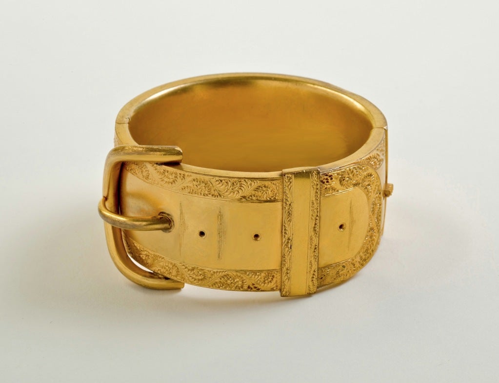 A Spectacular Victorian Gilt Metal cuff bangle, the bold buckle motif within etched floral boarders is an exceptional  example of period design and quality, Unsigned. Inside circumference approximately 6.25