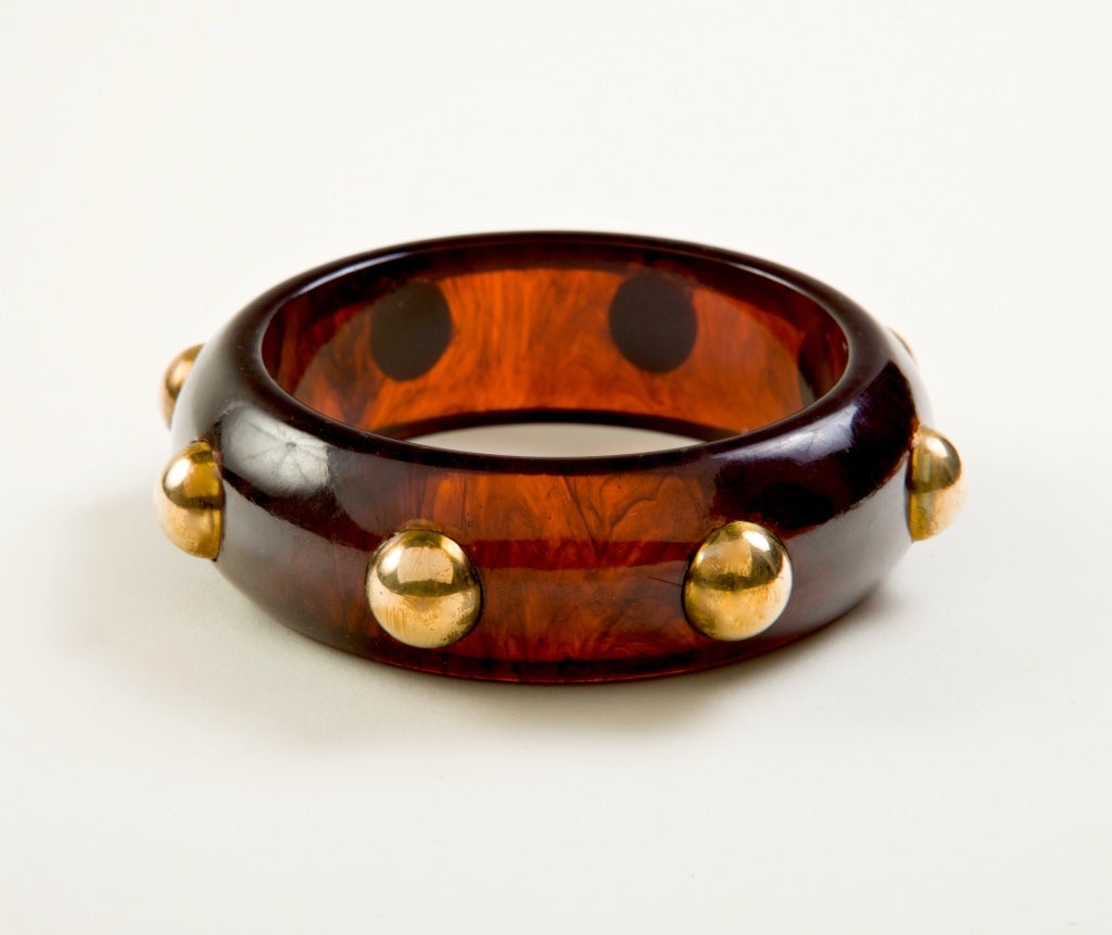 A Superb  and substantial vintage Bakelite Bangle, the richly colored faux tortoise shell cuff studded with large gold tone balls,  Unsigned. Inside circumference is approximately 8 inches.