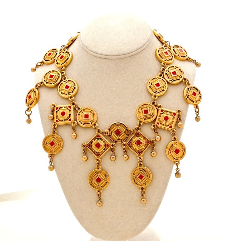 Stunning and Rare Claire Deve Geometric Collar Necklace with Matching Earrings in a fabulous warm gilt patina with red enameling.  A true statement piece circa 1980's.

Deve, a French designer who not only has her own studio but has also designed