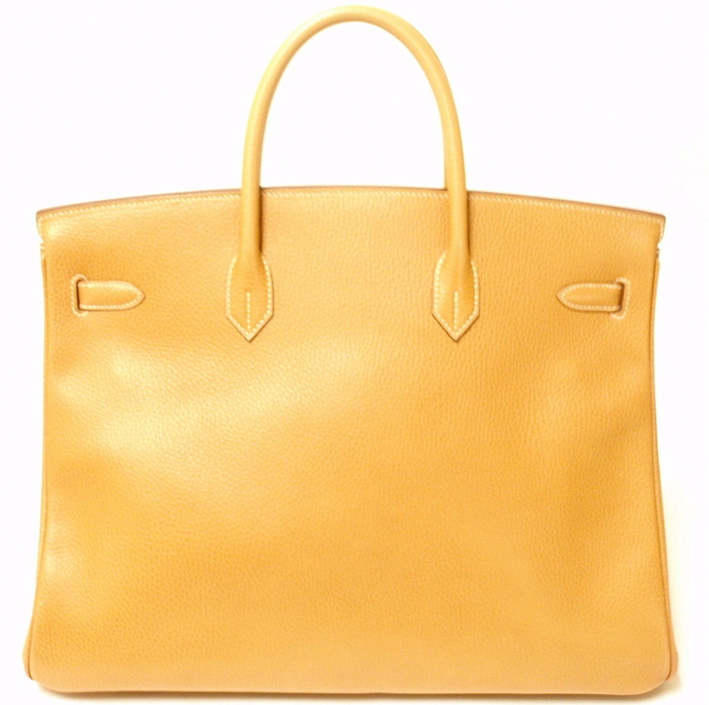 This Hermes Gold Togo Leather Birkin Bag is 40cm in size with golden hardware. Contrast white stitching on inside and outside. The front clasp is stamped HERMES-PARIS, and on the reverse side of the clasp is the blind stamp 