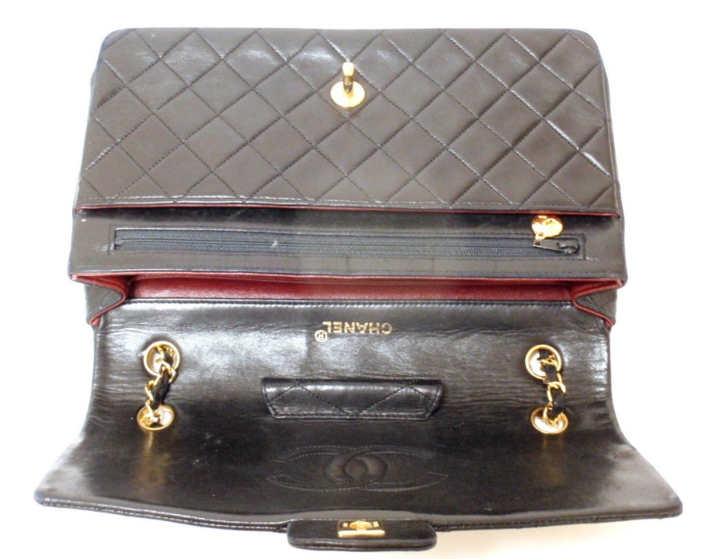 Chanel Single Flap Gold Hardware 27CM Handbag. With a rare interior including amazing useful compartments. Quilted lambskin with puffiness intact, an exterior pocket lined in red leather. On interior flap there is a quilted pen holder. On the