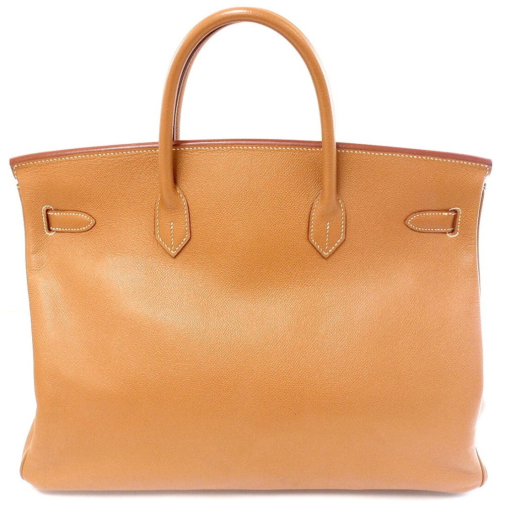 This Hermes Gold Courchevel Leather Birkin Bag is 40cm in size with golden hardware. The front clasp is stamped HERMES-PARIS, and on the reverse side of the clasp is the blind stamp 