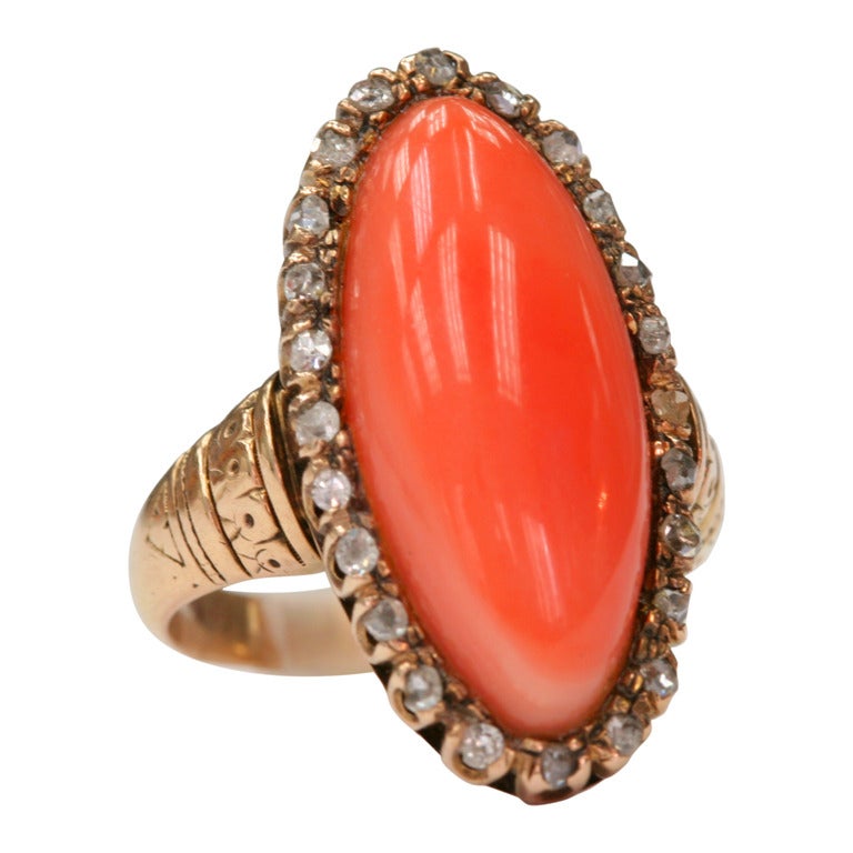 Coral center with 0.25cttw Rose cut accent diamonds set in a vintage 10kt yellow gold mounting. Circa 1890.