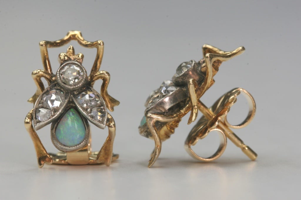 0.45cttw old European and Rose cut diamonds with opal accents set in vintage 18kt yellow gold mountings. Circa 1880.