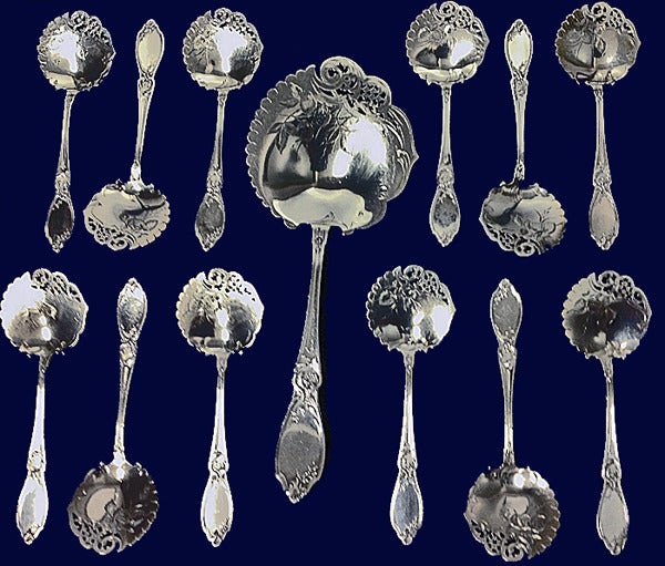 Rare Antique French First Standard (.950) silver strawberry set, Claude Doutre Roussel, Paris, C.1895, hallmarks of Minerva and maker's marks DR with double domino. The set comprising 12 strawberry spoons and larger server. The bowls of pierced