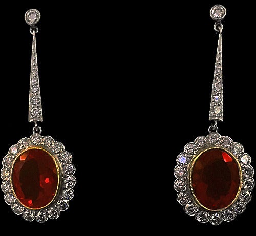 Fire Opal, Diamond, Platinum and 18K drop Earrings. English, 20th century. Fine milligraine bezel set fire opals gauging approximately 10 x 8 mm, each further set with 28 predominately full cut diamonds, total diamond weight approximately 0.50 ct,