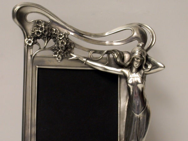 Rare Art Nouveau Frame, WMF Germany C.1905. No 18A. The frame of wonderful three dimension depicting graceful sinuous stylised female with flowing hair and dress; outstretched arm and gloved hand grasping foliage, the frame itself following the