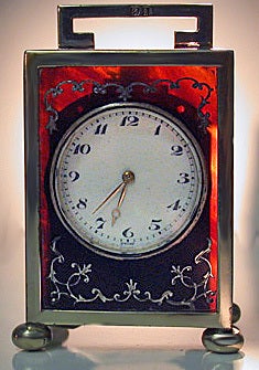 English Silver Carriage Clock, London 1924, Goldsmiths & Silversmiths Co. The silver clock on four bun feet with panels of silver inlay, hinged bracket art deco handle. Fully hallmarked and stamped on base The Goldsmiths & Silversmiths