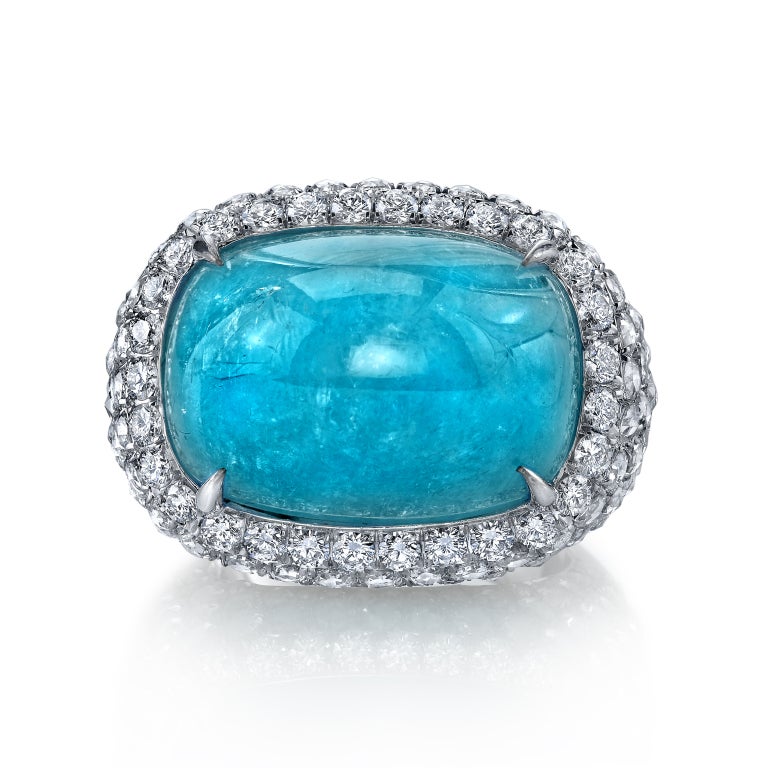 A rare and ultra exclusive 28.98ct cushion Paraiba Tourmaline cabochon, set in a luxuriously hand crafted platinum ring, accented by 3.46ct total of rose cut diamonds and 0.72ct total of round brilliant diamonds. 
Signed Tamir.