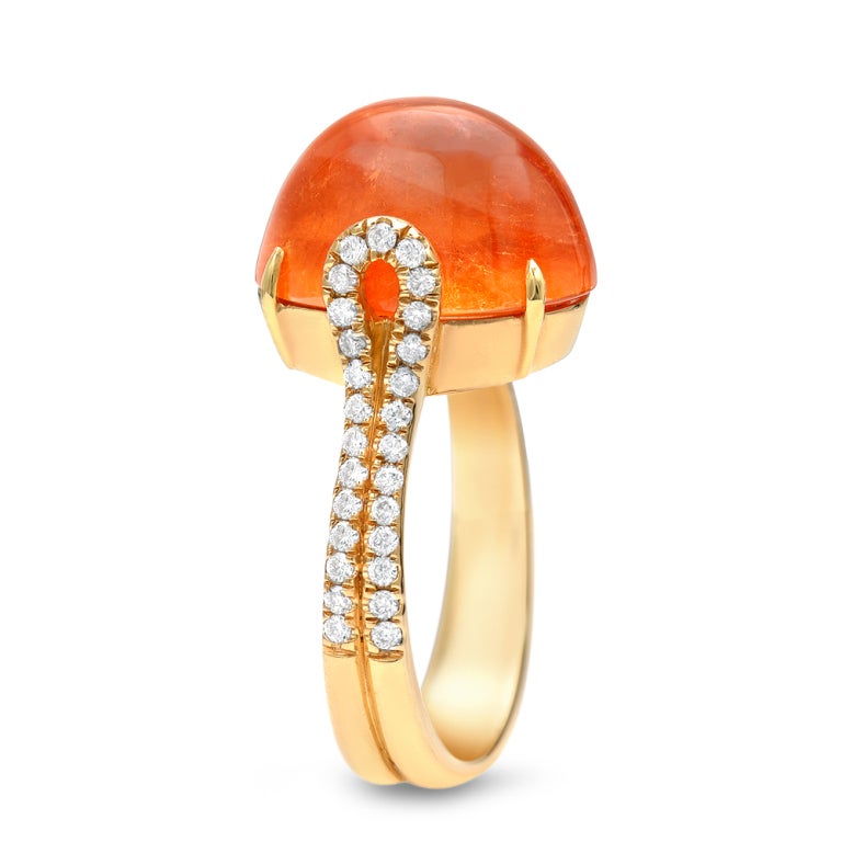 A 12.82ct bright and intense orange Mandarin Garnet cabochon, showcased in an 18K yellow gold ring with a total of 0.39ct diamonds.
Signed by Tamir.