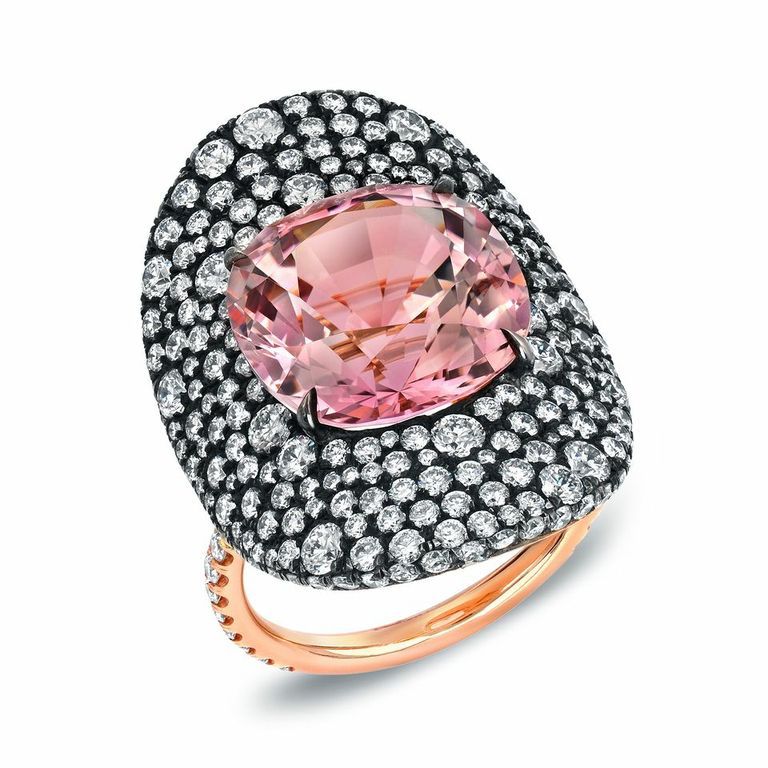 A vibrant 9.07ct cushion Pink Tourmaline and a total of 3.35ct diamonds showcased in a 18K 