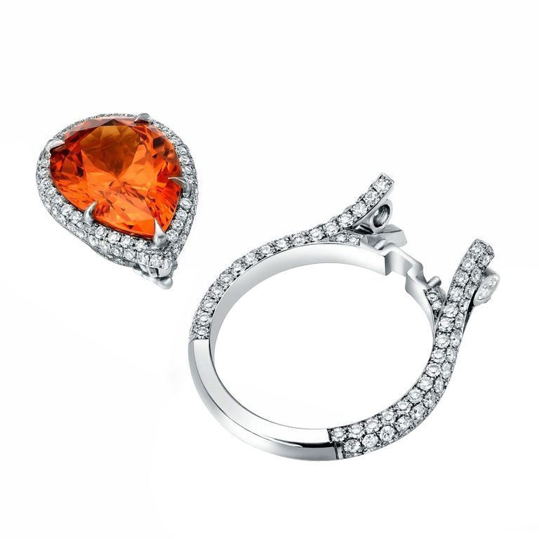 A master-crafted detachable ring-pendant comprised of a vivid 6.69ct pear shape Mandarin Garnet and 1.78ct single cut diamonds. Can be worn as a ring or a pendant.
Finger size 6. Can be sized to fit.
Crafted by hand in the USA.
Signed Tamir.