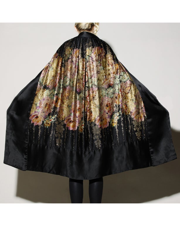 Flawless. We are not kidding. This is one of the most unbelievable things we have ever laid eyes on. This heavy silk opera cape is almost 100 years old and it looks unworn. No fading. No moth bites. No nothing. It is PRISTINE and gorgeous to boot.