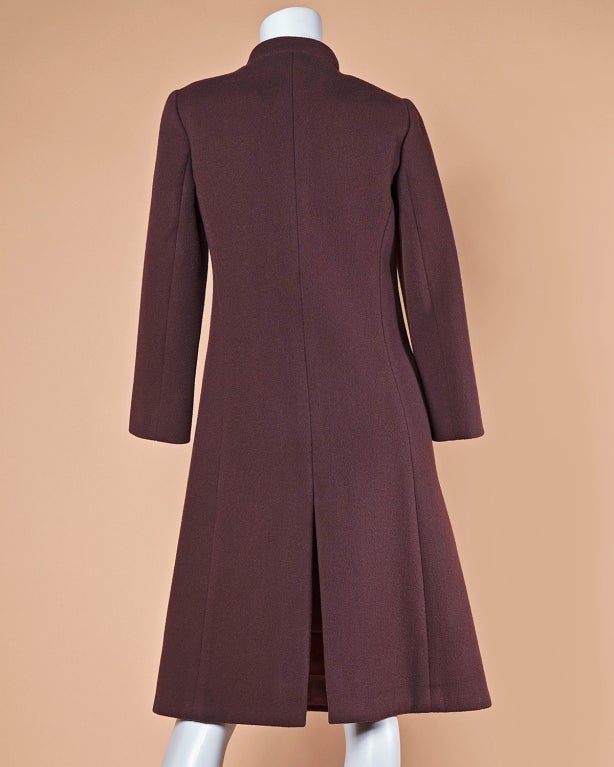 Chocolate brown vintage wool coat by iconic fashion designer Pierre Cardin. This coat features clean tailoring, asymmetric modernist button closure across the breast, and front pockets. Fully lined.

Measurements:

Bust: 32