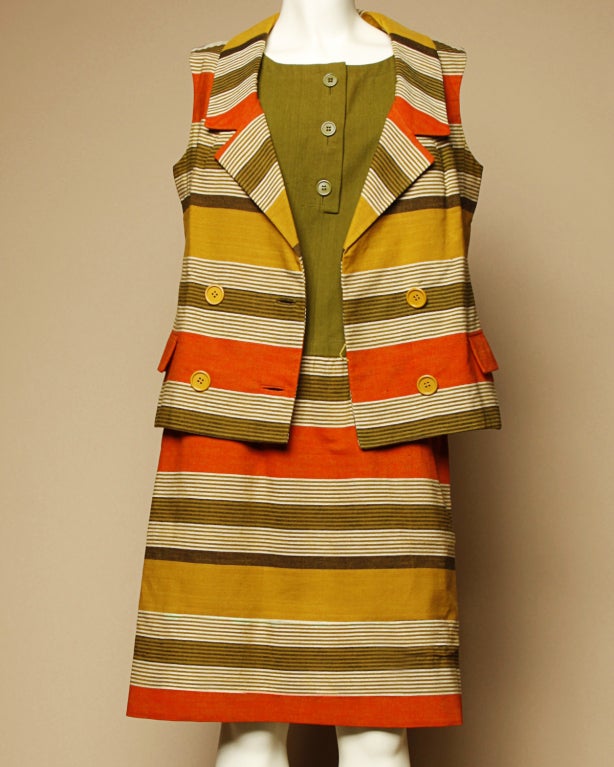 Bright striped Nina Ricci ensemble from circa 1960. Drop waist shift dress and matching vest/ jacket. Rear metal zip closure on the dress and front double breasted button closure on the vest. Vest is fully lined in silk. Dress is partially lined in