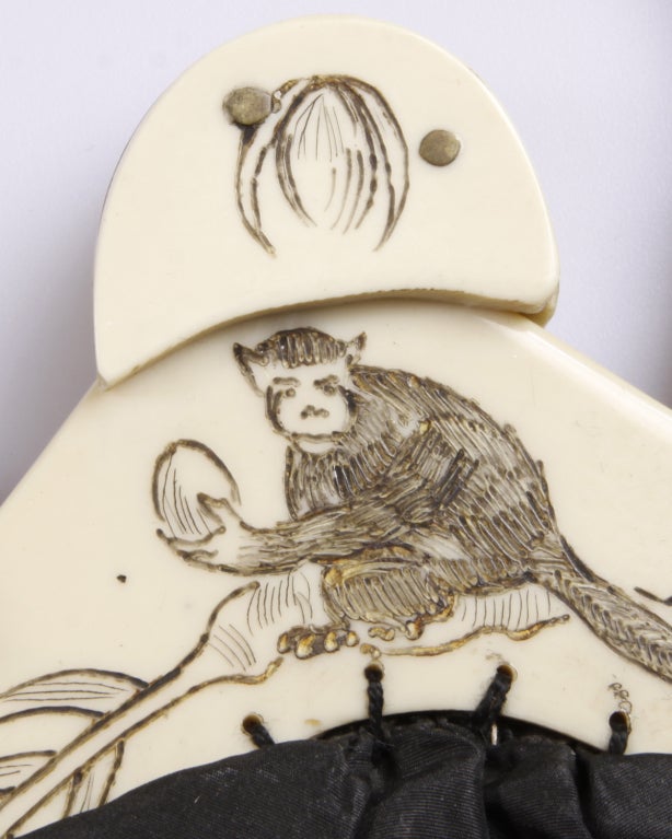 From the Suzanne Mounts Collection:

Victorian purse comprised of hand-etched celluloid frame, fabric, and trimmed in monkey fur. The celluloid frame is appropriately etched with a monkey holding a coconut. 

This purse is featured in the book