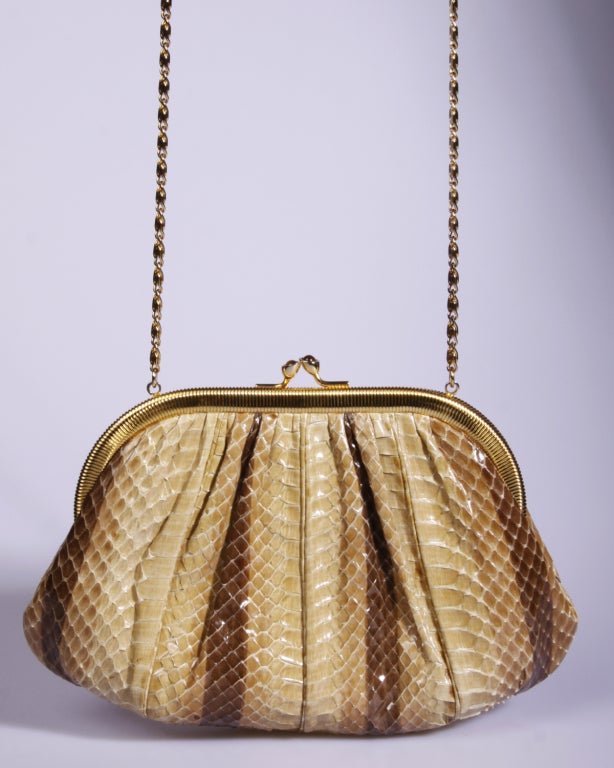 Beautiful genuine snakeskin bag by Judith Leiber. Gold tone hardware and Tiger's Eye stone clasp. The bag has a chain that tucks in so the piece can double function as a clutch. Sparkling clean interior with a zipper pocket and 