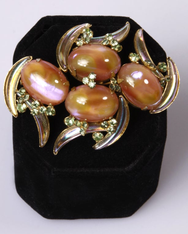 Description: One of our favorite pieces. Gorgeous iridescent half-moon shape and cabochon ovals in tones of watermelon and vanilla are accented with a sprinkling of tiny round cut rhinestones. Slightly curved, this beautiful brooch is a welcome