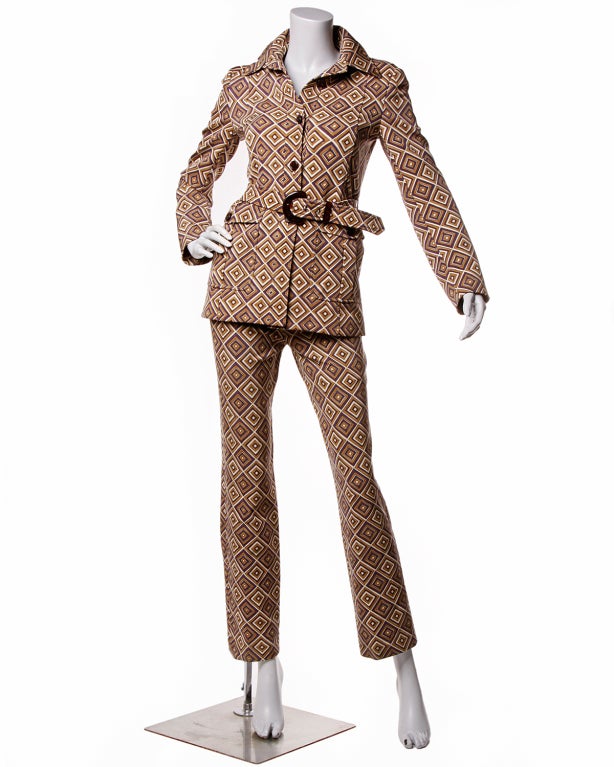 Heavy geometric pattern made a statement as part of Prada's fall/winter collection 1996 and this suit was the focus of many a magazine cover and fashion review. Creme, plum and mocha geometric diamond pattern. Skinny pant, structured jacket with