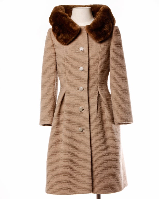 Classic ribbed wool Lilli Ann coat with a buttery soft scalloped pop up fur collar. Some of the softest fur you will ever lay your hands on! Apricot lining and inverted pleats with heavy plastic matching buttons. Clean lines and flattering