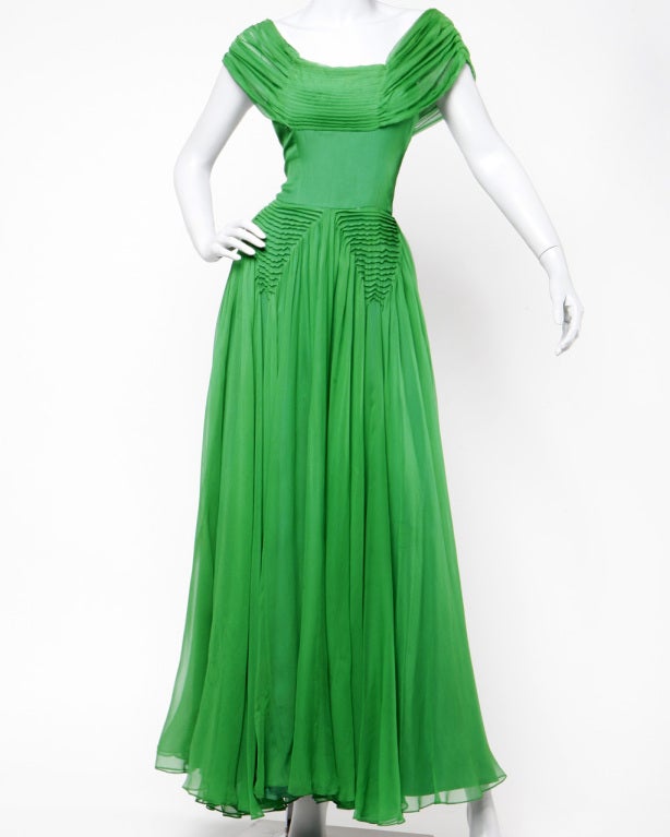 The perfect synthesis of delicate and bold! Delicate light-as-a-feather silk chiffon in a bold and bright kelly green color. Full sweep skirt that swings when you walk. Triangle shaped pin tucking at the waist and neckline. Metal zip closure. Fully