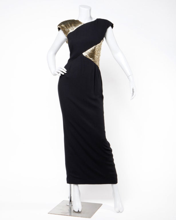 Classy metallic gold and black evening dress by Valentino. This dress features an asymmetric ruched metallic gold infinity illusion bustline that wraps one shoulder and the bodice of the dress. Flattering shape with a touch of Disco. Back slit.