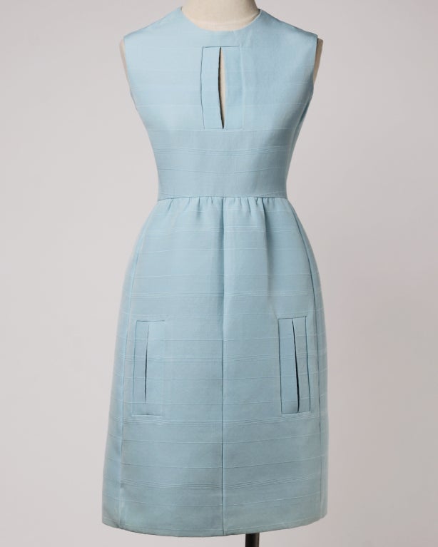 Unworn Donald Brooks baby blue vintage dress with the original Bullock's Wilshire tag still attached. Slit pockets and cut out keyhole at the bust. Sleeveless sleeves. Rear zip closure. Partially lined.

Clean construction with hand stitching