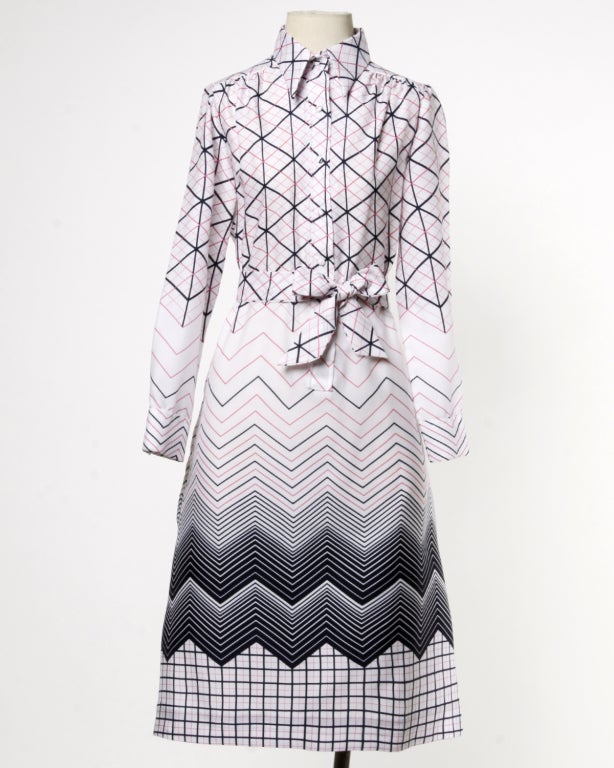 Fantastic 1970's pink, navy and white shirt dress by Lanvin for Maison Mendessolle. Geometric modernist print, matching sash and pointed collar. Front button closure/ unlined.

This dress should fit a modern size medium to