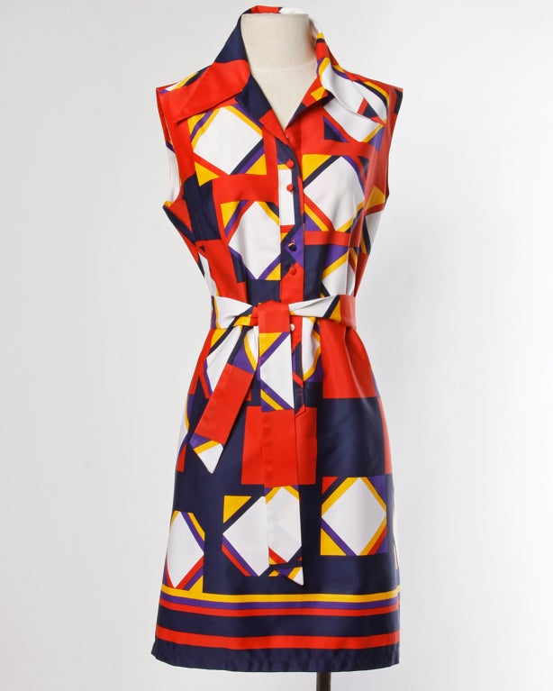 Brightly colored geometric print shirt dress by Lanvin. Button up front, sleeveless sleeves and matching waist sash. Unlined.

MEASUREMENTS

Bust: Up to 40