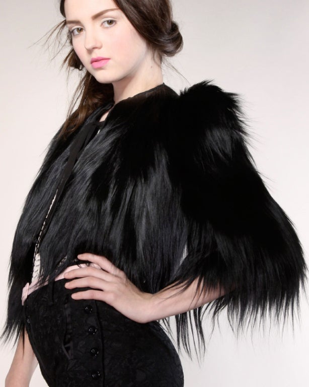 Long, jet black, glossy genuine monkey fur bolero jacket from the 1940s. Extremely rare find and in great condition! These are becoming harder and harder to find. Fully lined. Front hook closure.
 
*Note: Fur is Colobus guereza ssp. guereza and is