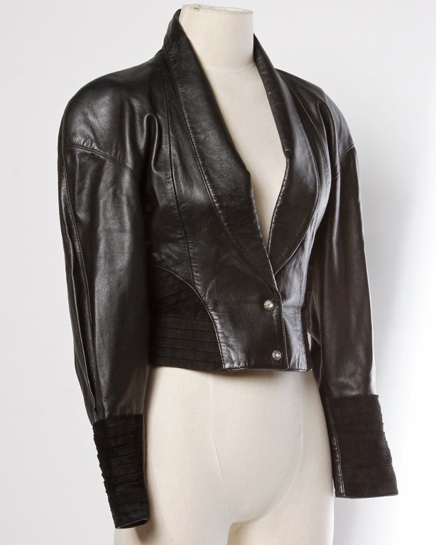 Vintage Michael Hoban for North Beach Leather cropped leather jacket from the 1980's. The jacket features unique suede pleats on the arm cuffs and on the waistband. Rounded lapels and bold shoulders. Front snap closure. Fully lined.

Bust:
