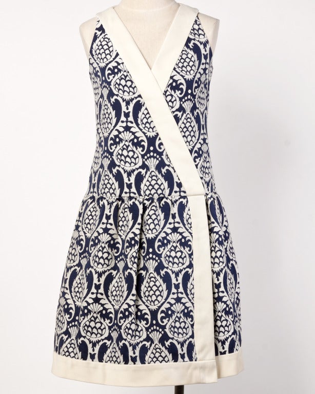 Navy and off-white tapestry fabric drop waist dress and wrap set by Teal Traina. Gorgeous construction on both pieces which can be worn as a set or separates. Dress is fully lined and zips up the back.

DETAILS:

Circa: 1960s
Label: Teal