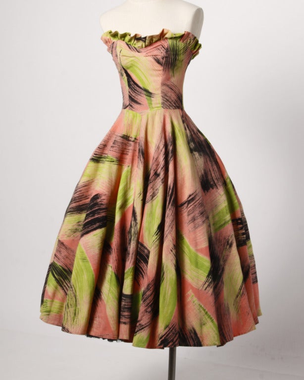Extraordinary 1950's vintage full circle strapless party dress and matching wrap in gorgeous hand painted neon fabric. Broad brush strokes in neon coral, lime and black make this ensemble a true vintage work of art. Made in Mexico by the infamous