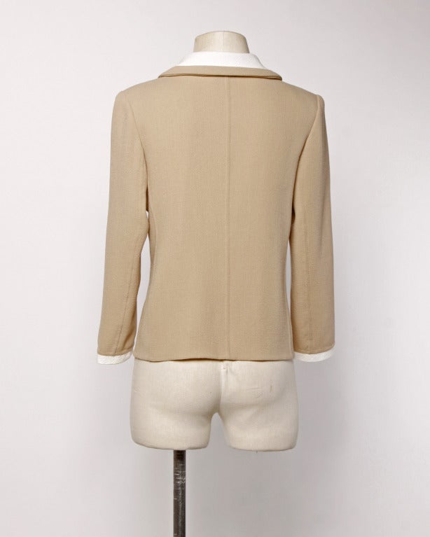 Two tone beige and white jacket by Bill Blass. Heavy shell buttons and a peter pan collar. Structured shoulder pads can be removed if desired.

DETAILS:
Unlined
Front button and hook closure
Circa: 1990s
Label: Bill Blass
Estimated Size: