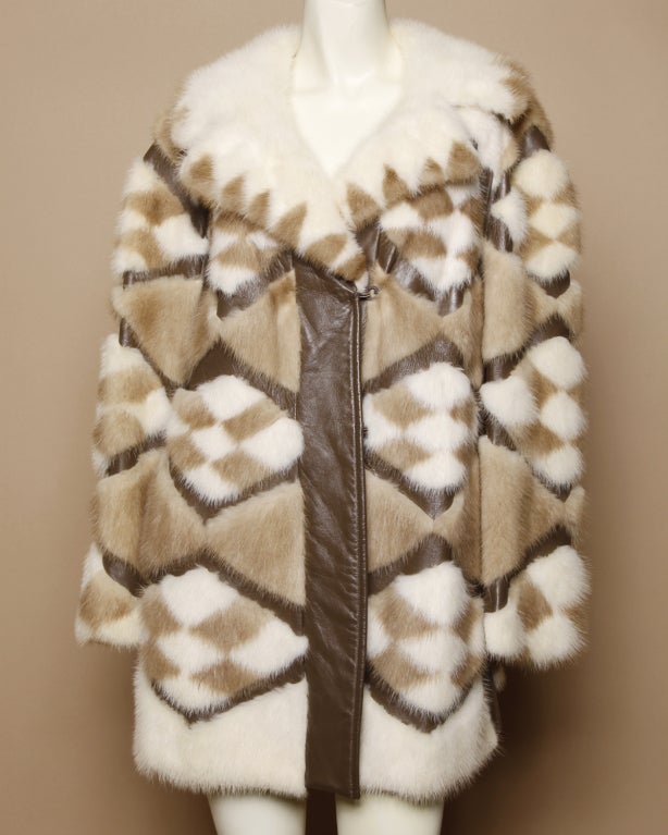 Fantastic two-toned mink fur coat with a mod diamond design and leather paneling. Fully lined. Front hook closure. Side pockets. Mongram 'JLM' sewn onto inner lining. 

DETAILS:

Circa: 1960s
Estimated Size: S-M
Color: Creme / Mocha /