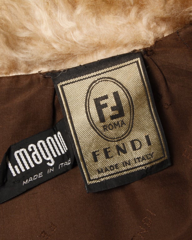 An extraordinary and unique shaggy Mongolian lamb fur coat by Karl Lagerfeld for Fendi. This dramatic piece features batwing/ cape style sleeves and long curly lamb fur that has been dyed ombre hues of brown, umber, rust and honey. The buttons are