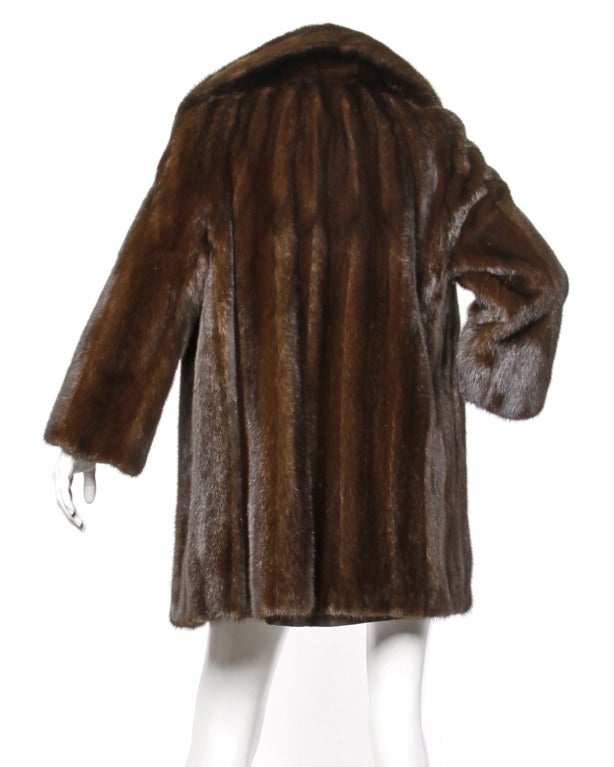 Dark chocolate brown silky and plush mink fur coat with a pop up collar and silk satin lining. Gorgeously matched pelts with ultra long guard hairs. Coat closes in front with a single hook closure.

DETAILS:

Fully lined
Front hook