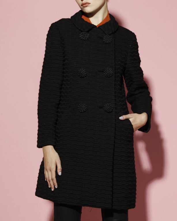Quality textured wool coat by Seymour Fox. Fully lined. Front double breasted button and snap closure. Front pockets.

DETAILS:

Circa: 1960s
Label: Seymour Fox
Estimated Size: S
Color: Black
Fabric: Wool

MEASUREMENTS:

Bust: