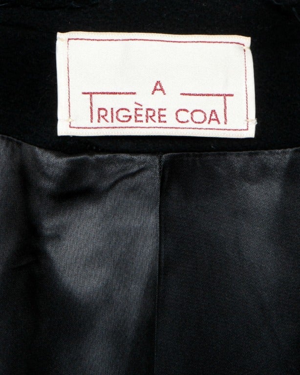 Gorgeous heavy black wool cape coat by Pauline Trigere. Military detailing and front arm slits.

DETAILS:
Fully lined
Front button closure
Interior front pockets
Circa: 1970s
Label: Trigere
Marked Size: 10
Estimated Size: S / M / L
Color: