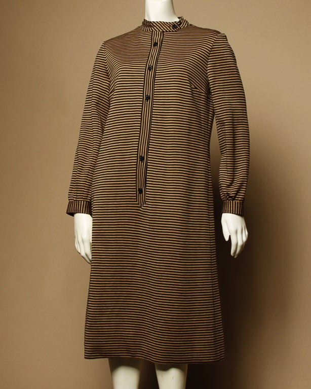Simple and chic camel and black striped wool knit shift dress by Givenchy. Fully lined in silk. Front button and snap closure.

Details:

Circa: 1970's
Designer: Givenchy
Color: Camel/ Black
Estimated Size: S-M

Measurements:

Bust: