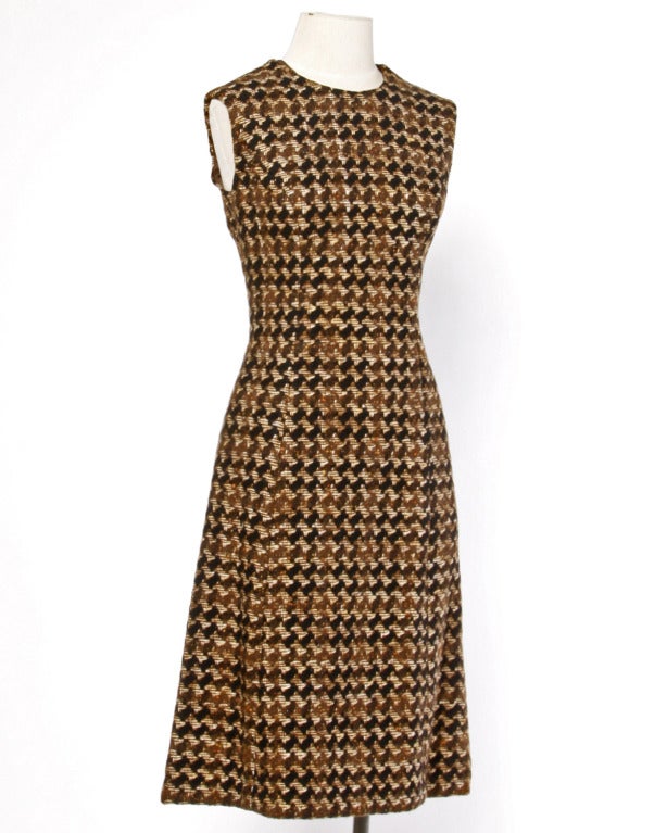 Phenomenal vintage coat and sheath dress set by Adele Simpson. Heavy brown houndstooth wool on both pieces! The coat features double breasted button closure and the dress zips up the back. Both pieces are fully lined and in excellent