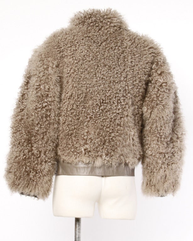 Fantastic long and shaggy Mongolian lamb bomber jacket with taupe buttery leather trim, a snap up front and champagne satin lining. Side pockets. Neiman-Marcus tags attached on the inside.

Oversized shape should fit a S-L depending on desired