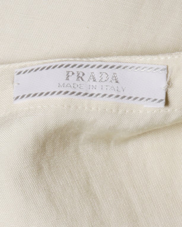 Darling Prada mini dress with a drop waist and pleated hemline.

DETAILS:

Unlined
Side Zip Closure
Circa: 1990s
Label: Prada
Marked Size: 40
Estimated Size: M-L
Colors: Off White
Fabric: 60% Silk 40% Linen

MEASUREMENTS:

Bust: