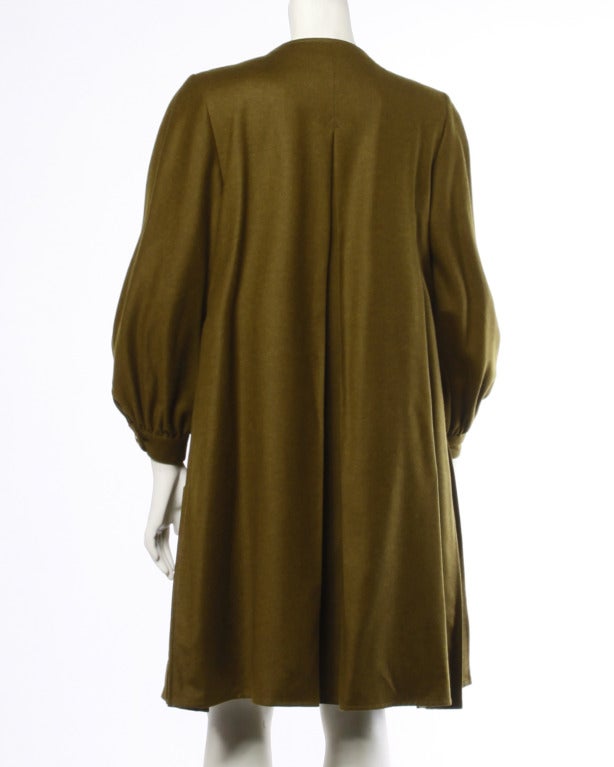Olive green wool/ cashmere blend swing coat with military detailing and full sleeves. Fully lined with front zip closure.

Details

Circa: 1990s
Label: Christian Lacroix Pret A Porter
Marked Size: 
Estimated Size: Medium
Color: Olive