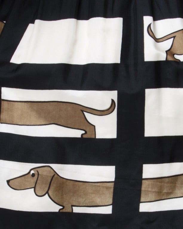 Darling novelty print silk dress featuring brown daschund dogs on a geometric window pane design. By Saks Fifth Avenue.

Unlined
Back Metal Zip and Hook Closure
Circa: 1960s
Label: Saks Fifth Avenue
Estimated Size: XS-S
Colors: Black / Ivory