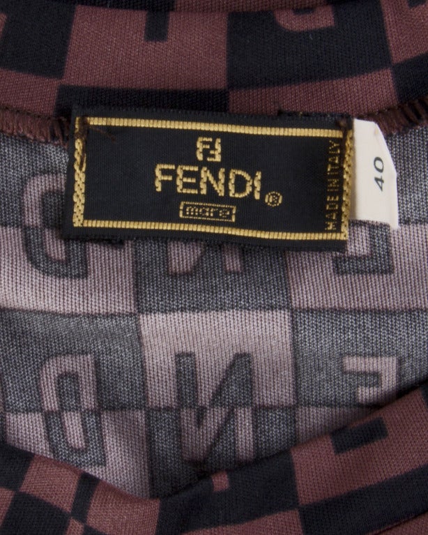 Sexy body con mini dress by Fendi Mare. Body hugging light weight stretchy fabric is printed in a geometric 