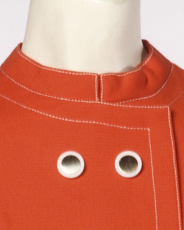 High quality red-orange wool shift dress by Pat Sandler. Contrasting white stitching, mirror buttons and mod detailing. Fully lined with rear zip and hook closure.