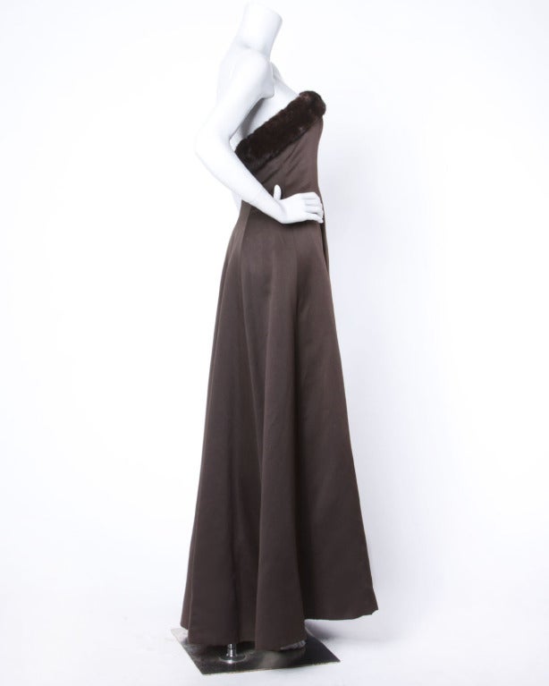 Chocolate brown satin gown by Nahdree for Victor Costa. Strapless with genuine mink fur trim. Boned bodice and built in bra. Fully lined with rear zip and hook closure. Marked size 6 but fits more like a modern 2-4.