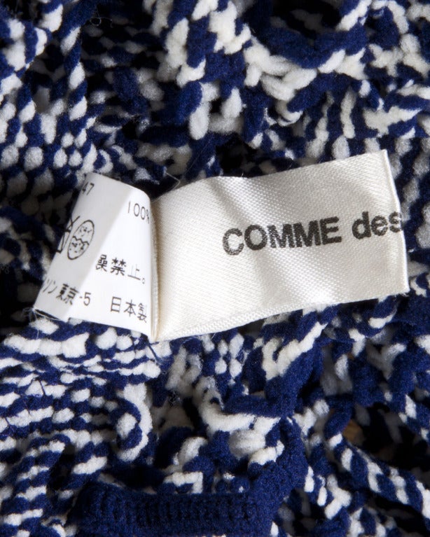 Amazing blue and white hand knit mesh top by Comme des Garcons which features a cut out design. Long sleeves and stretchy fabric. Incredible design! Unlined.

This top should fit a modern size XS-M.
