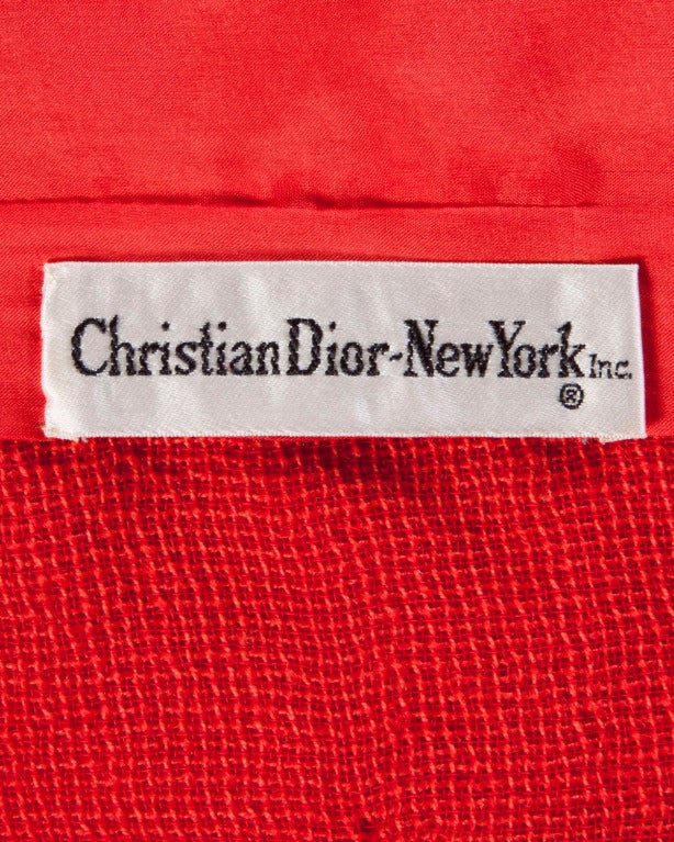 Stunning red-orange woven 3-piece suit set by Christian Dior for Saks Fifth Avenue circa 1960's. The three pieces can be worn together or separately and are all perfectly tailored.

The jacket is lined and features front frog closure. The skirt